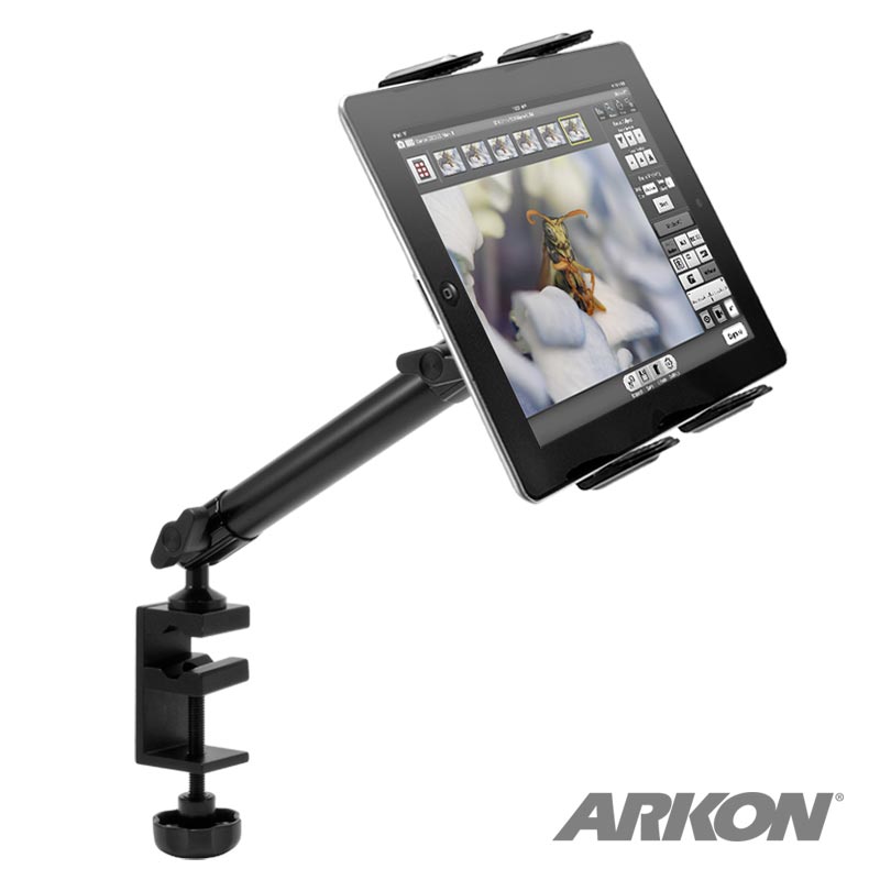A Slim-Grip® Tablet Holder with Clamp Base and Extension Arm in black holds a tablet showing a butterfly image. The ARKON logo is visible in the bottom right corner.
