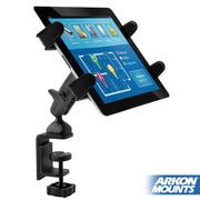 The Slim-Grip® Tablet Holder with Heavy-Duty Clamp Mount securely holds a tablet with a colorful touchscreen, attaching to the edge of a surface. The ARKON MOUNTS logo appears at the lower right corner.