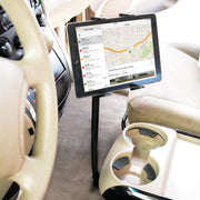 The Slim-Grip® Tablet Holder with Seat Rail Mount and 18 Bendable Arm is installed near the cup holders between the driver’s seat and center console, holding a tablet that shows a navigation map and list of locations.