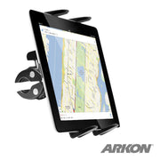 A tablet displaying a digital map is held in the Slim-Grip® Tablet Mount with Clamp Base. The ARKON logo appears in the bottom right corner.