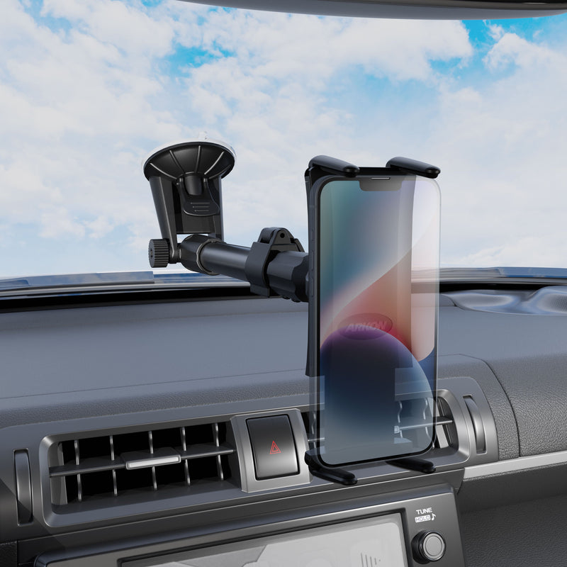 A Slim-Grip® Ultra Holder with Suction Mount holds a smartphone on the dashboard near the air vent, with a blue sky visible through the windshield.