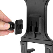 A close-up shows a hand holding a small black mount by the back of the Slim-Grip® Universal Tablet Holder w/ Dual-T mounting pattern, highlighting its quick and easy attachment to this versatile holder.