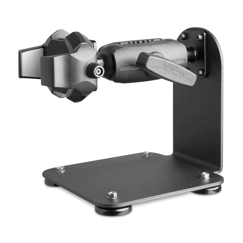 The SteadyMag™ Magnetic Mount System with RoadVise® Ultra Phone Holder is a black, adjustable metal mount with a sturdy L-shaped base and padded clamps, perfect for securely holding phones or tablets on desks, workstations, or warehouse vehicles.
