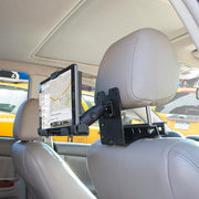 A Taxi Headrest Tablet Mobile Printer Payment Terminal Mount (4-Hole AMPS compatible) holds a tablet on a gray leather car headrest, displaying a map app. Other vehicles can be seen outside the car.