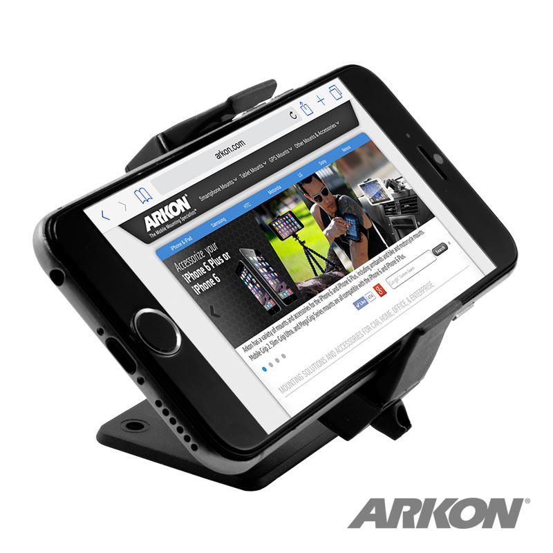 A black smartphone is mounted horizontally on the Universal Smartphone Adhesive or Drill-Base Mount VSM Adapter Kit for Car Installation, displaying an Arkon phone accessories website with the ARKON logo at the bottom right.