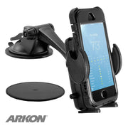 A black Mega Grip™ Windshield or Dash Phone Car Holder Mount for iPhone, Galaxy, and Note secures a phone with a weather app. The mount features adjustable arms, an adhesive pad, and the Arkon logo in the lower left corner.