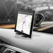 A Windshield Suction Slim-Grip® Tablet Mount holds a tablet on the dashboard, displaying a navigation map while the blurred road can be seen through the windshield in the background.